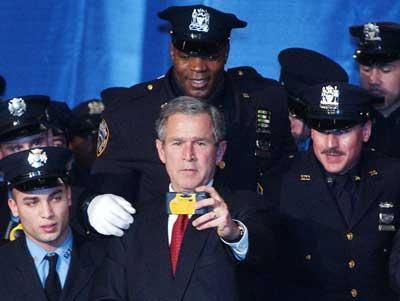 RFD has George W's back!
The big guy behind President Bush with his hand on his shoulder is Riverhead's own Fire Police Patrol member Ron Myers, who is also a NYPD Sergeant. So who needs the secret service?  Photo courtesy of Newsday